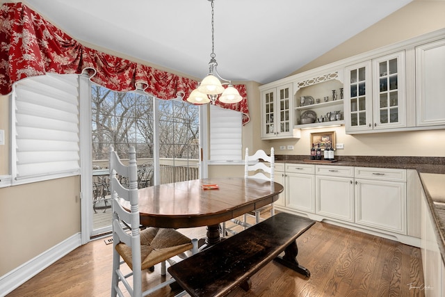 dining area with lofted ceiling and light hardwood / wood-style floors