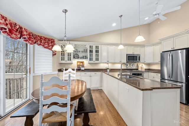 kitchen featuring white cabinetry, appliances with stainless steel finishes, and a kitchen island with sink