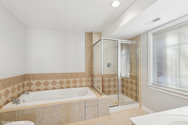 bathroom featuring tile patterned floors and separate shower and tub