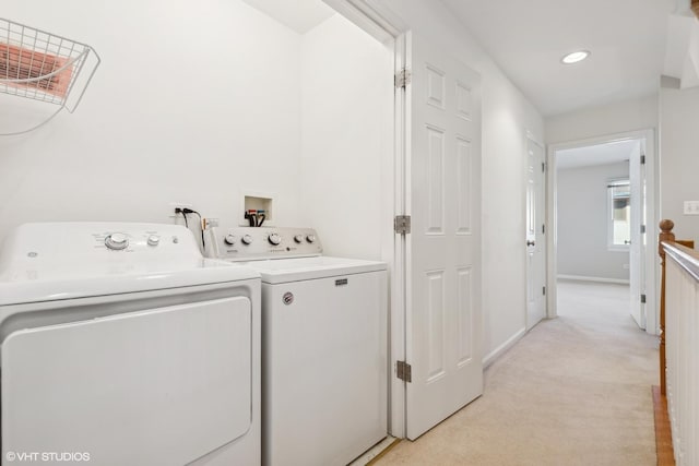 clothes washing area featuring washer and dryer and light carpet