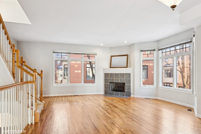 unfurnished living room featuring a fireplace and light wood-type flooring