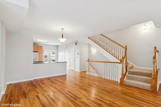 unfurnished living room featuring light wood-type flooring