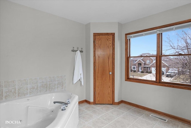 bathroom featuring tile patterned floors and a bathtub