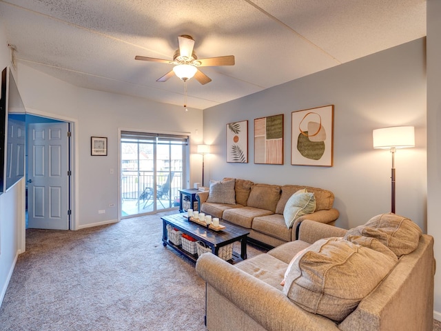 carpeted living room with a textured ceiling, baseboards, and a ceiling fan