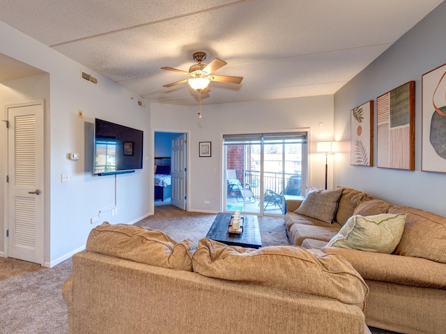 living area featuring light carpet, ceiling fan, visible vents, and baseboards