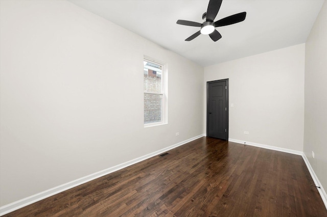 empty room featuring ceiling fan and dark hardwood / wood-style floors