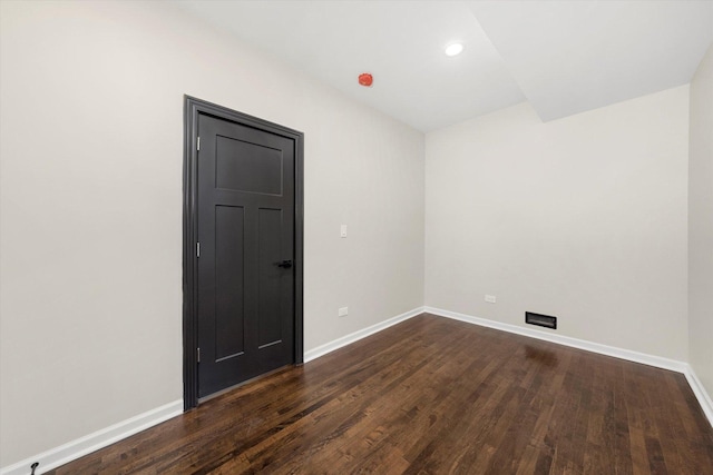 spare room with dark hardwood / wood-style floors