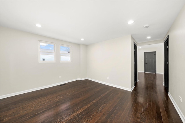 unfurnished room with dark wood-type flooring