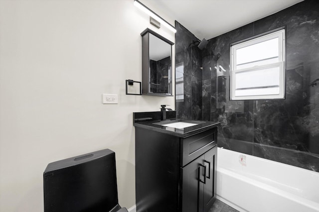 bathroom featuring tiled shower / bath, vanity, and tile patterned floors