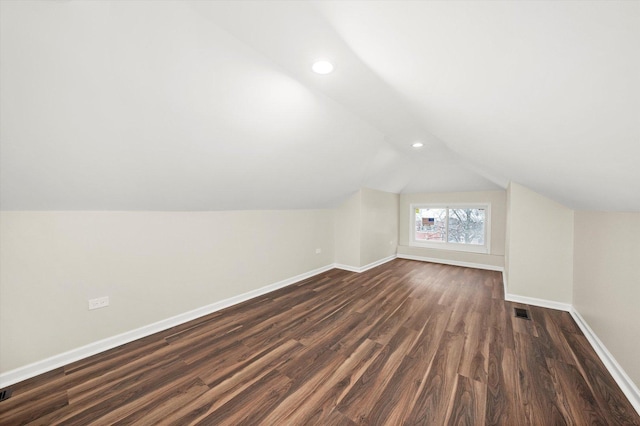 additional living space with lofted ceiling and dark hardwood / wood-style flooring