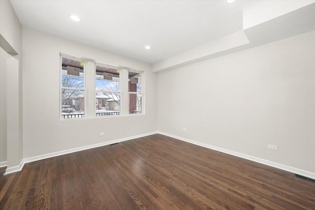 spare room with dark hardwood / wood-style floors