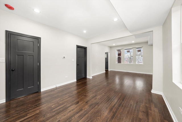 unfurnished living room with dark wood-type flooring