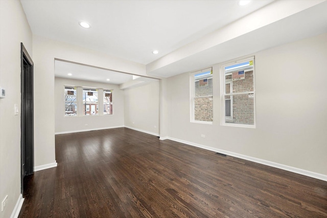 spare room with dark hardwood / wood-style flooring