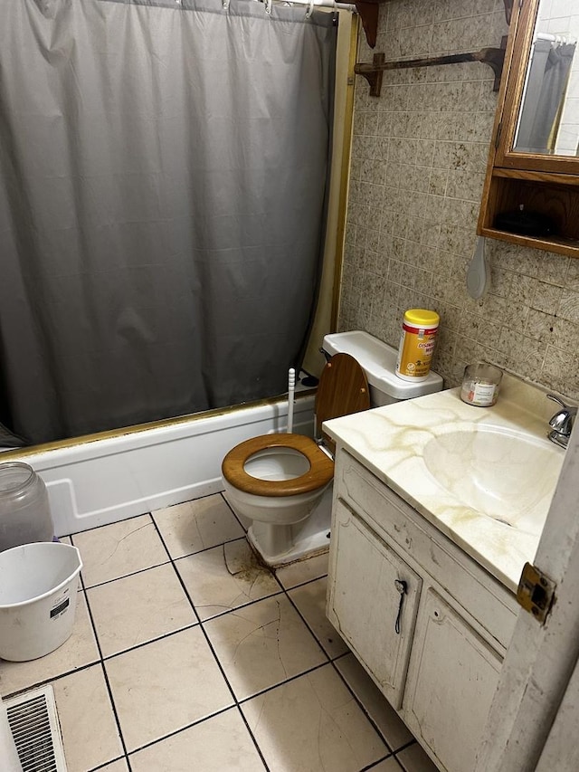 full bathroom featuring tile patterned flooring, vanity, shower / tub combo, and toilet