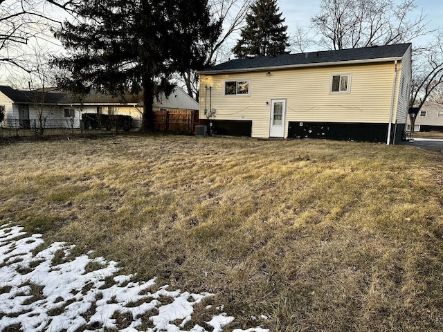 snow covered property with a yard and central air condition unit