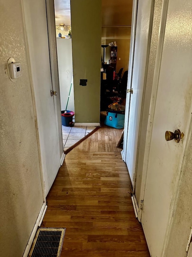 hallway with hardwood / wood-style floors