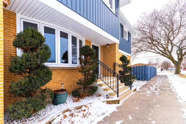 view of snow covered property entrance