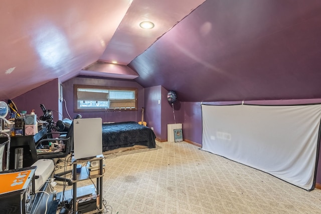 carpeted bedroom with lofted ceiling