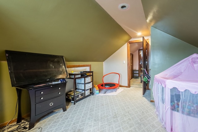 carpeted bedroom with lofted ceiling