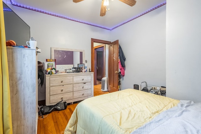 bedroom with wood-type flooring and ceiling fan