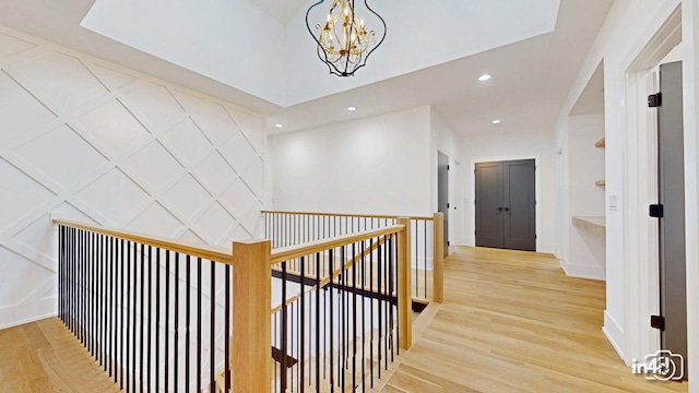 corridor featuring a notable chandelier and light hardwood / wood-style floors