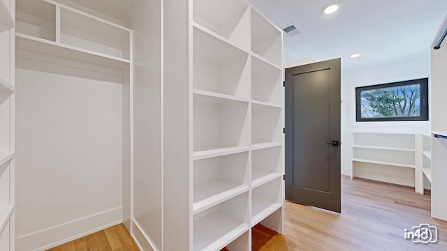 walk in closet with light wood-type flooring