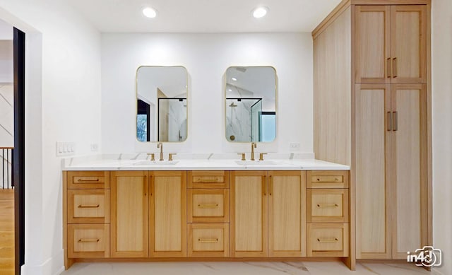 bathroom with vanity and a shower with door