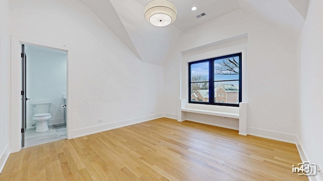 interior space featuring vaulted ceiling and light wood-type flooring