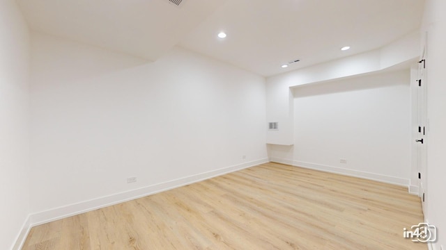 empty room with light hardwood / wood-style flooring