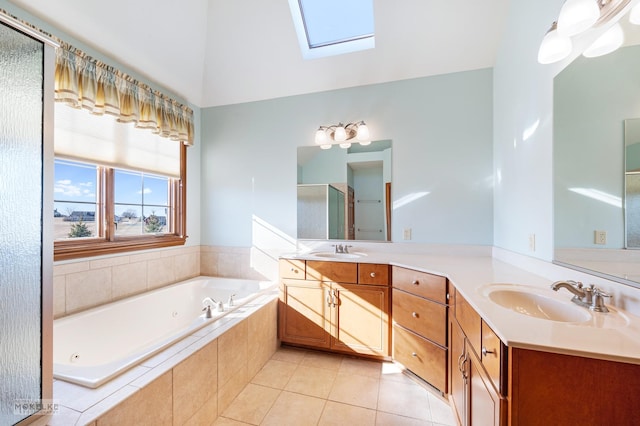 bathroom with tile patterned floors, plus walk in shower, vaulted ceiling with skylight, and vanity