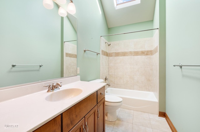 full bathroom with tiled shower / bath, a skylight, vanity, toilet, and tile patterned floors