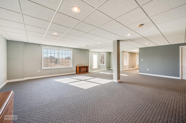 basement with dark carpet and a drop ceiling