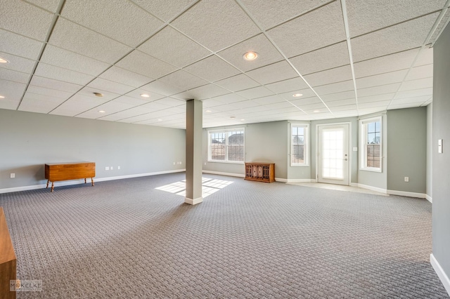 basement featuring a paneled ceiling and carpet floors