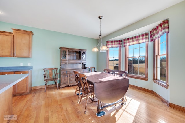 dining area with a notable chandelier and light wood-type flooring