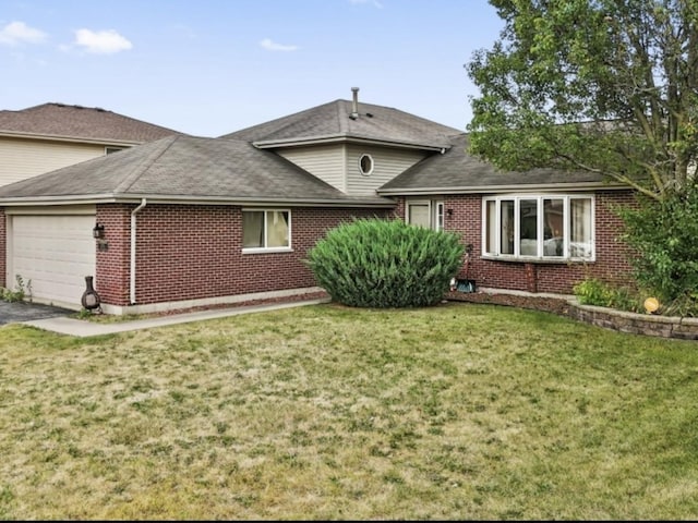 single story home featuring a garage and a front yard