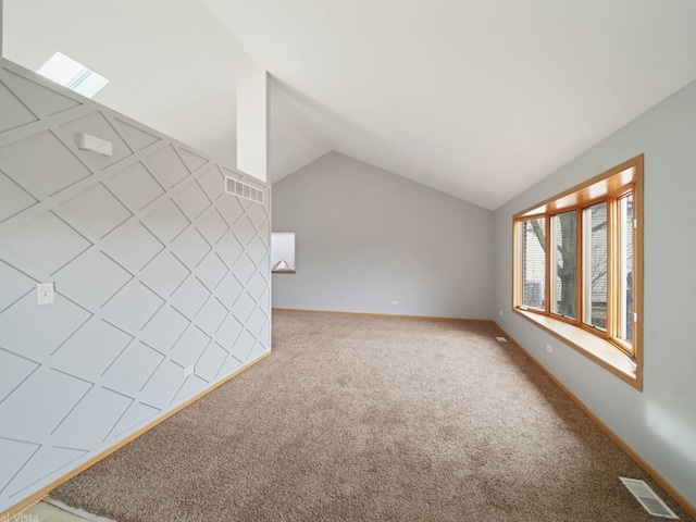 carpeted spare room featuring lofted ceiling