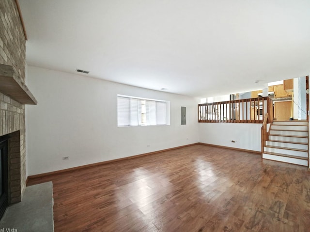 unfurnished living room with wood-type flooring and a fireplace