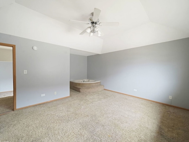 carpeted empty room with ceiling fan and lofted ceiling