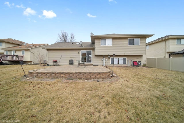 rear view of property with a lawn and a patio