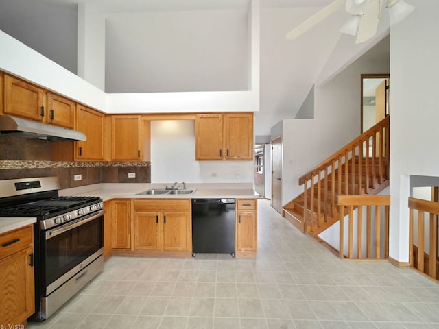 kitchen featuring stainless steel gas range, sink, tasteful backsplash, black dishwasher, and a towering ceiling