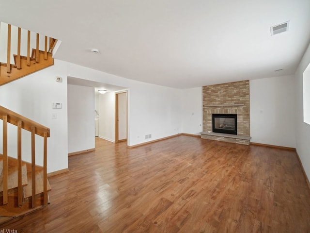 unfurnished living room with a fireplace and light hardwood / wood-style flooring