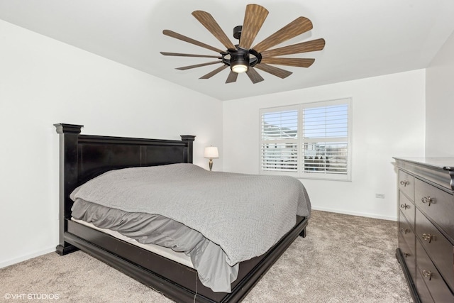 bedroom with ceiling fan and light colored carpet