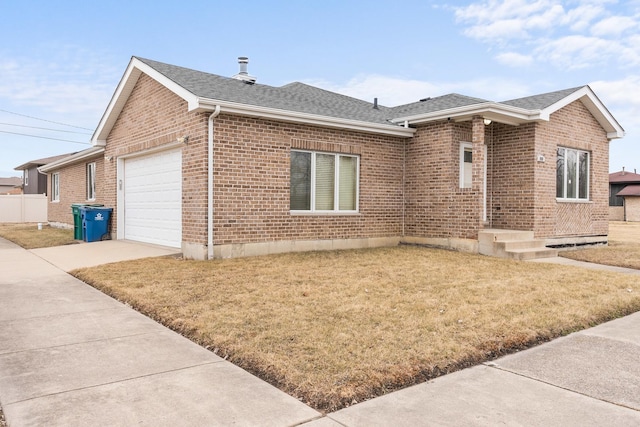 ranch-style home with a garage and a front yard