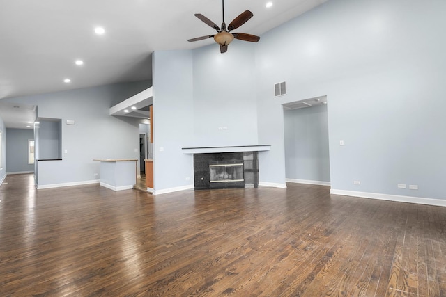 unfurnished living room with ceiling fan, high vaulted ceiling, dark hardwood / wood-style floors, and a fireplace