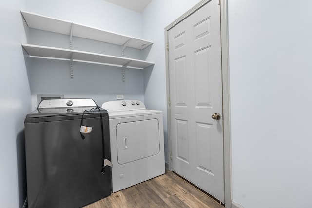 laundry area with wood-type flooring and independent washer and dryer