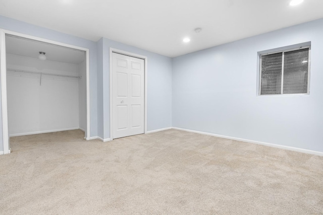 unfurnished bedroom featuring light carpet