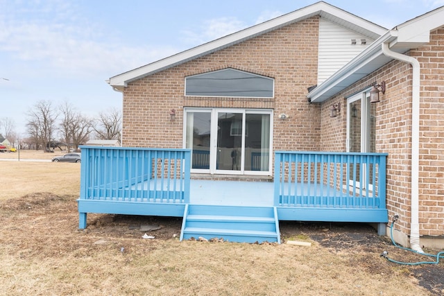 view of side of home featuring a wooden deck and a lawn