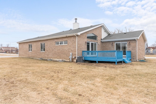 rear view of house featuring central AC, a deck, and a lawn