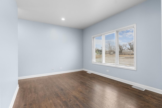 spare room featuring dark hardwood / wood-style floors