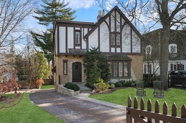 english style home with a front yard